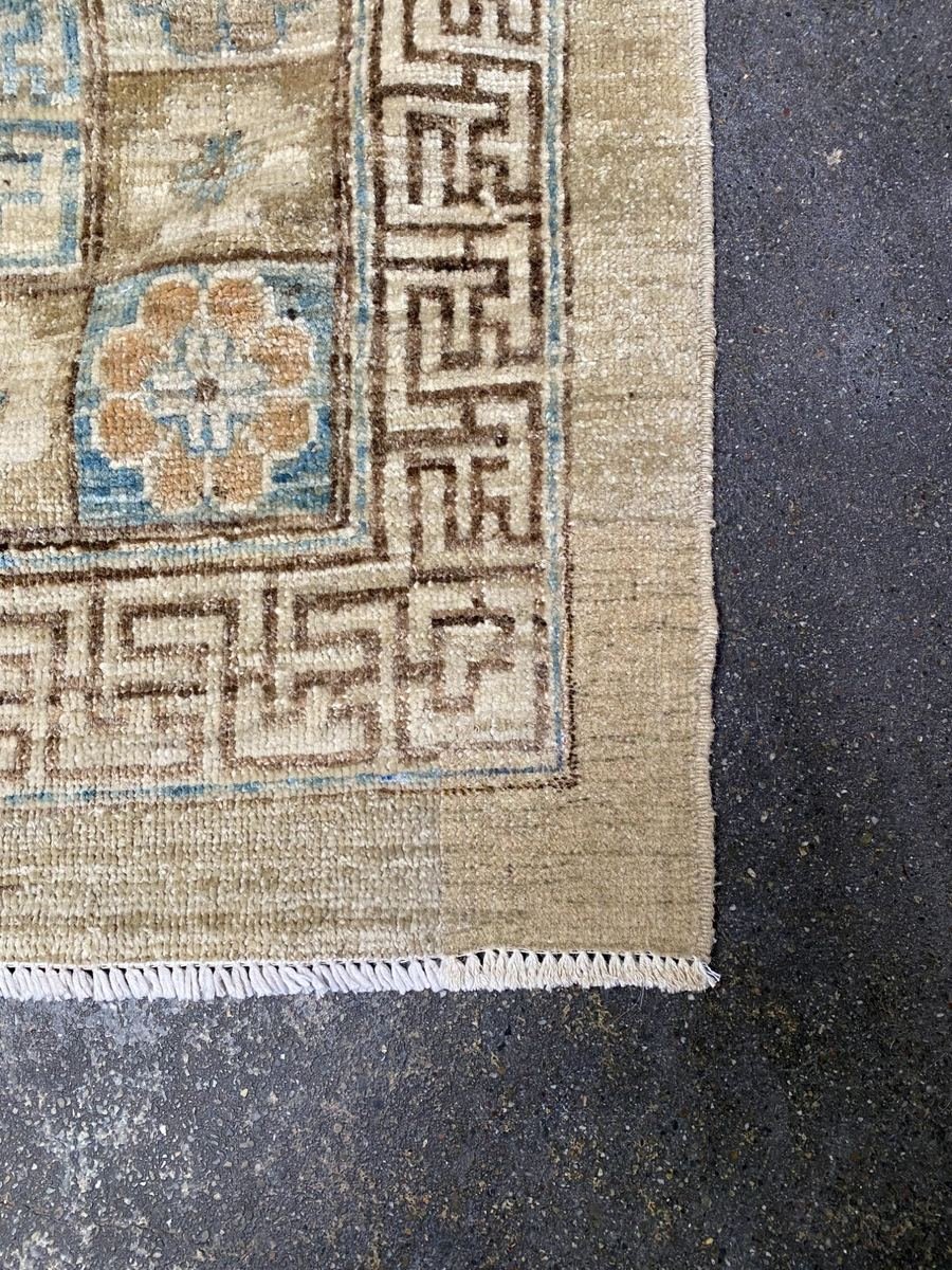 The same Khotan rug fully restored — corner rewoven and fringe replaced by master weavers