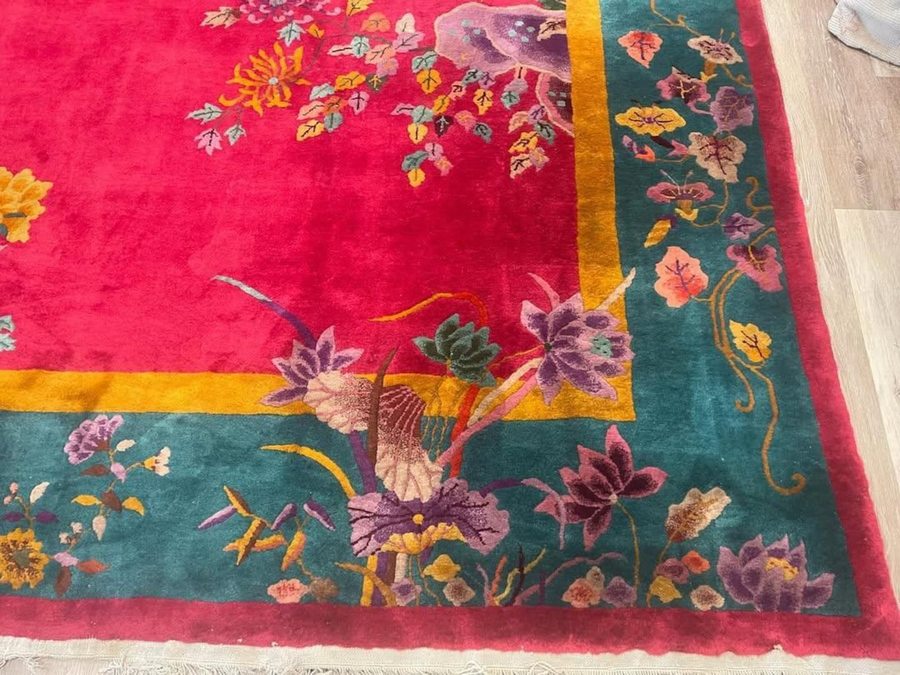 Chinese Art Deco rug corner detail with vivid red ground teal border gold trim and carved floral motifs