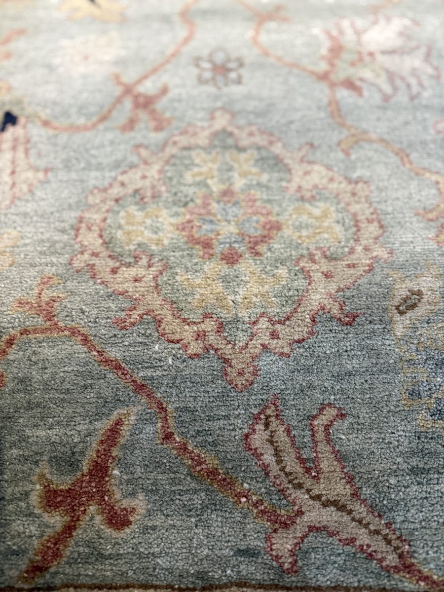 Egyptian workshop rug — blue-grey field with floral arabesque