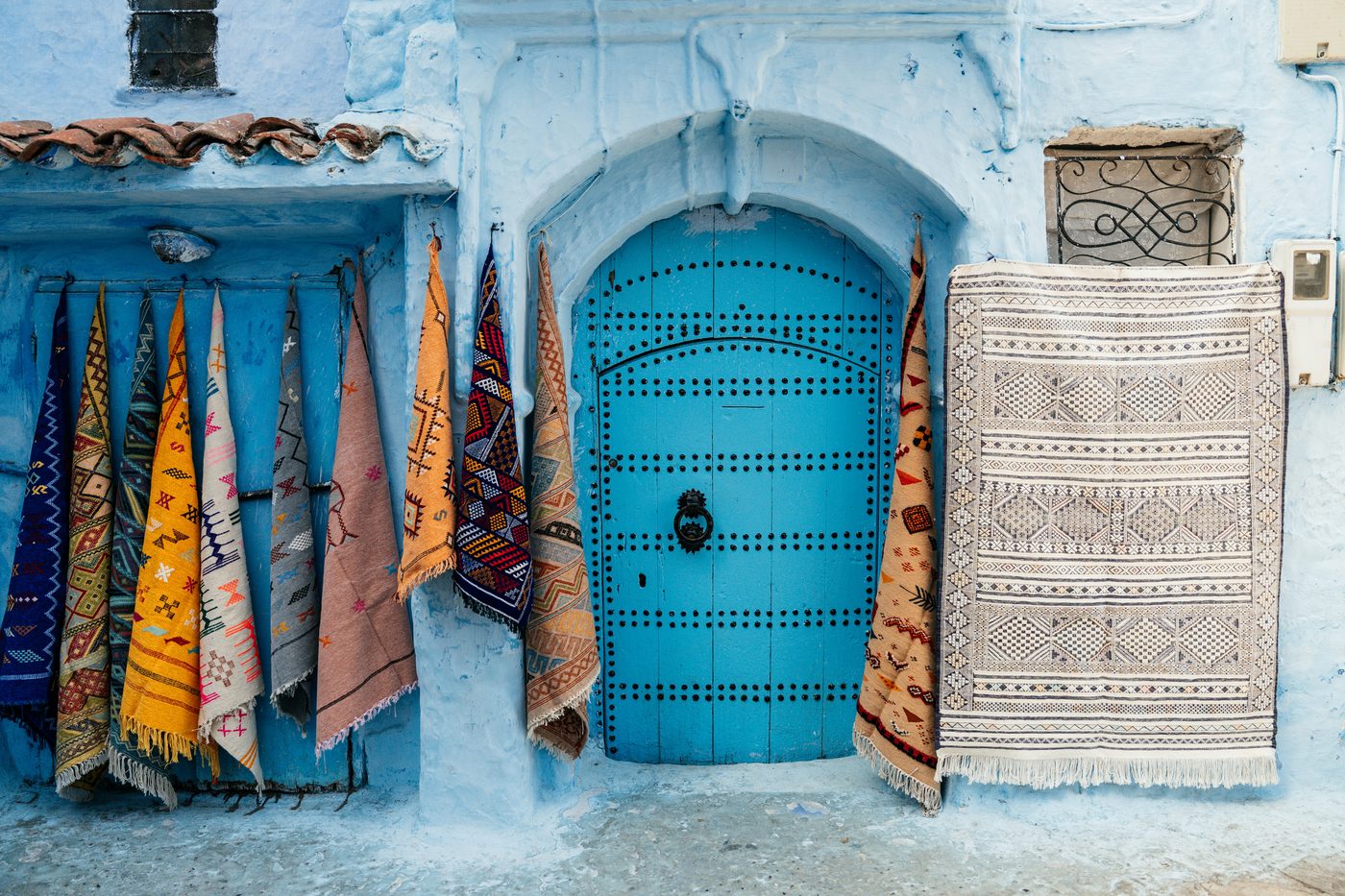 Moroccan rugs displayed in Chefchaouen medina