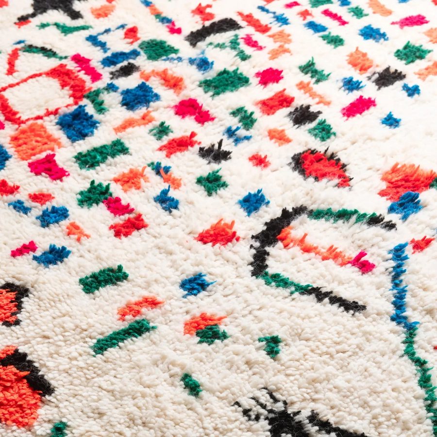 Azilal rug — colorful symbolic motifs on ivory ground