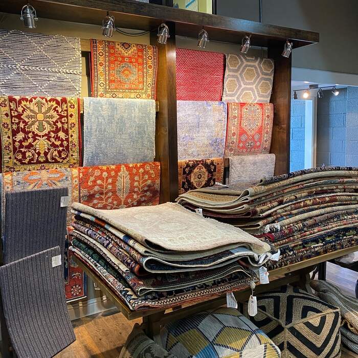 Stacks of handmade rugs on the Simonian showroom floor