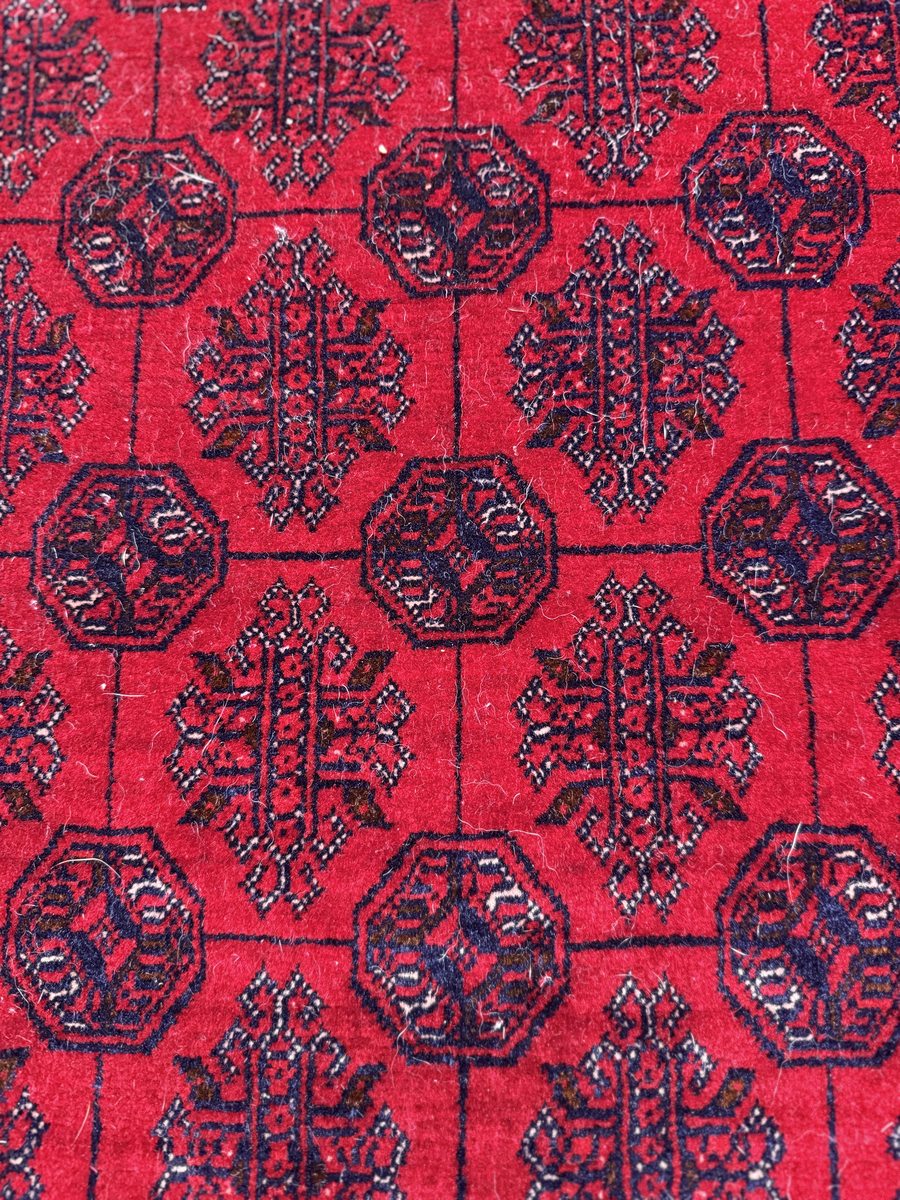 Tekke main carpet — deep crimson field with precise octagonal guls