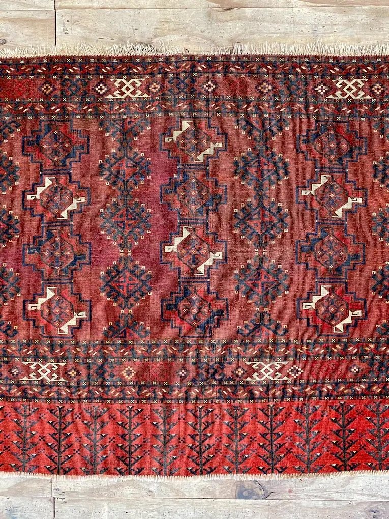 Ersari tribal rug — warm red field with geometric guls
