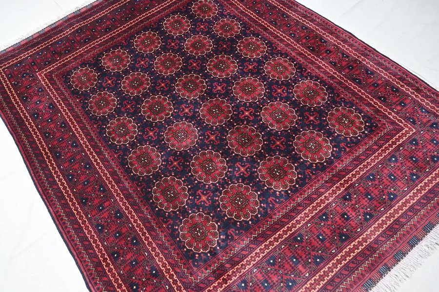 Salor Chaudor Turkmen rug — navy field with red floral gul repeat
